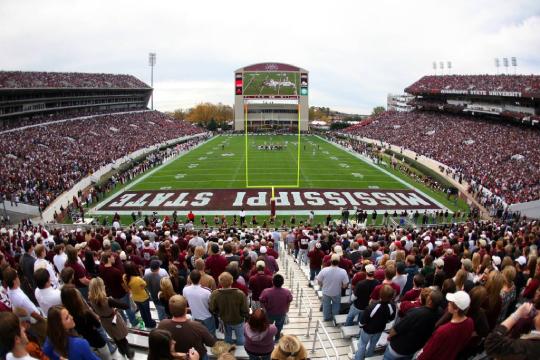 a stadium with people in front of a crowd